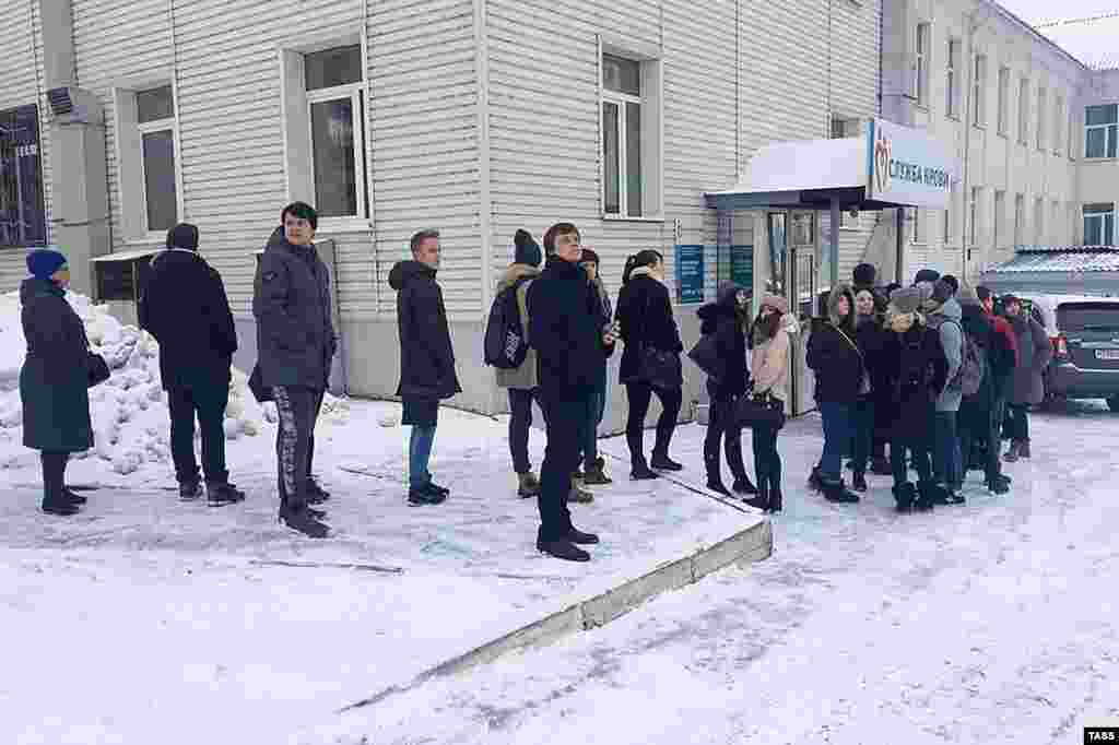 People line up to give blood to help the victims.