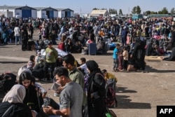 Afghan returnees are pictured at the Islam Qala border crossing between Afghanistan and Iran on June 28, 2025.