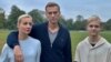 Aleksei Navalny, his wife, Yulia, and son Zahar pose for a picture in Berlin in an image obtained from social media on October 6.