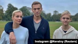 Aleksei Navalny, his wife, Yulia, and son Zahar pose for a picture in Berlin in an image obtained from social media on October 6.