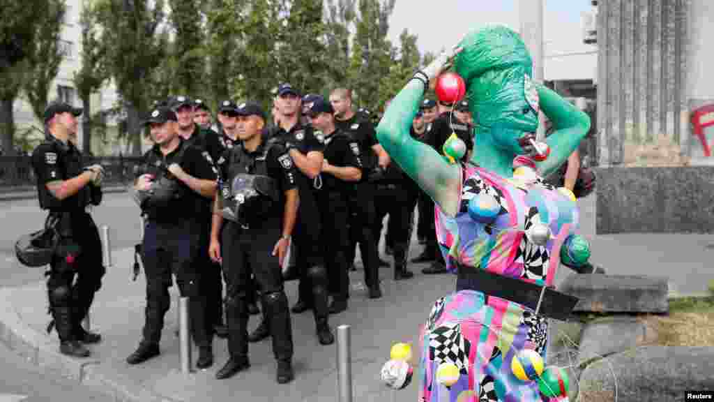 Police look on as a parade participant ambles past.&nbsp;