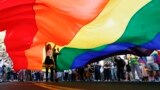 SERBIA -- Participants walk under a rainbow flag during the annual gay pride in Belgrade, September 15, 2019