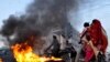 Pakistani Shi&#39;ite Muslims burn tires during a protest against the suicide bombing that killed dozens of their community members in the Lakhi Dar area of Shikarpur, in Karachi, Pakistan, on January 30. (epa/Shahzaib Akber)