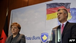 Kosovar Prime Minister Hashim Thaci (right) with German Cancellor Angela Merkel during a press conference at Pristina International Airport