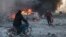 People try to extinguish fires following an air strike that targeted Syria's rebel-held northern city of Idlib on December 2. Since Russia intervened in the civil war in Syria, its aerial attacks have played a crucial role in propping up Syrian President Bashar al-Assad.