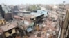 Men remove debris following clashes between people demonstrating for and against a new citizenship law in New Delhi on February 27. REUTERS/Rupak De Chowdhuri