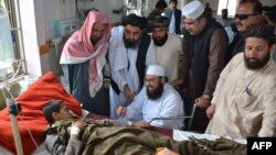 Deputy chairman of Pakistan's Senate, upper house of Parliament, Maulana Abdul Ghafoor Haideri (C), who survived a May 12 suicide bomb attack, visits an injured blast victim at a government hospital in the southwestern city of Quetta on May 16.