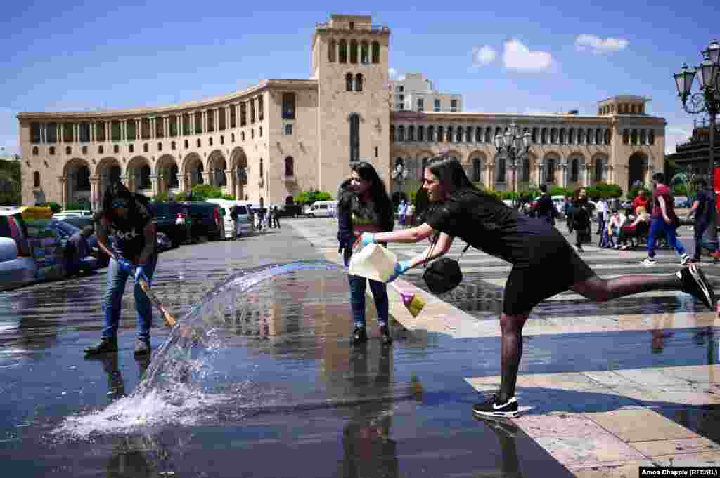 Sona Ghazaryan, 20, cleaning Republic Square with university classmates. The linguistics student said her group headed to the square, which was the scene of a huge protest rally one night earlier, after classes finished and would spend three hours scrubbing it clean. “We have come here because we love our country, and we want to show our support for what is happening on the streets," she told RFE/RL. "I want everything in my country to be fair. We all love Armenia and we want the best for her.”