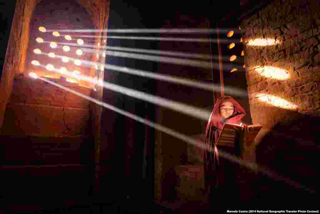 "LightSource," by Marcelo Castro. Old Bagan, Burma. "Young Monk finds a perfect light source to read his book inside of his pagoda."