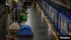 Residents take shelter inside a Kyiv metro station during an air raid alert as Russian drone and missile strike continued across the country early on February 17. 