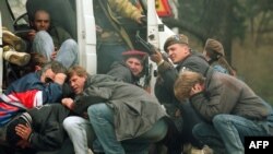 A Bosnian special forces soldier returns fire downtown Sarajevo, April 6, 1992