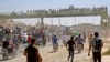 Syrians chant slogans and wave flags of the opposition as they protest against a promised government assault on Idlib province.