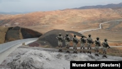 Turkish forces man the new border wall along the Turkish-Iranian border in Turkey's Van Province. 