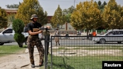 A Taliban fighter stands guard after a blast in front of the Russian Embassy in Kabul in September.