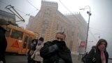 A woman covers her nose as smog blankets Sarajevo, Bosnia and Herzegovina December 23, 2015.