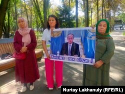 A group of people whose relatives are in Xinjiang camps ask President Qassym-Zhomart Toqaev for help in Almaty on September 5.