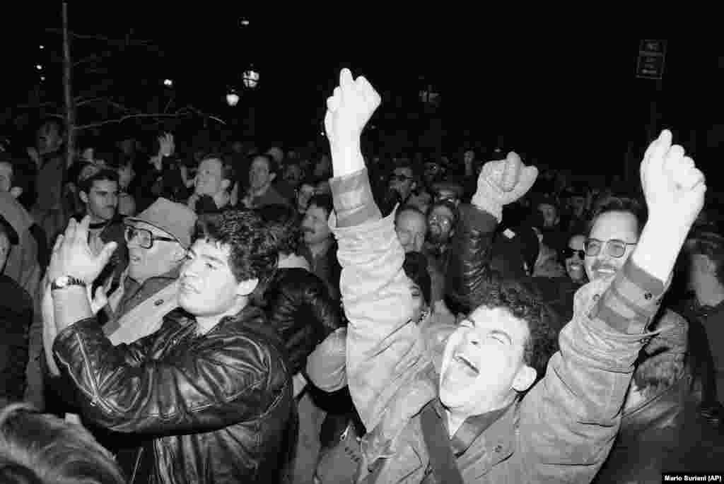 People celebrate in the New York City neighborhood of Greenwich Village after a gay-rights bill is passed on March 20, 1986.