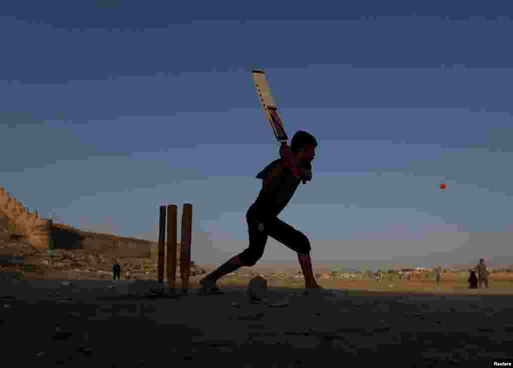 Afghan boys play cricket on a playground in Kabul. (Reuters/Mohammad Ismail)