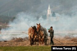 A villager in Maramures County takes a drink while preparing his fields for spring in 2010.