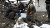 Ukraine -- Ukrainian volunteers looking for dead bodies (teaser photo), undated.