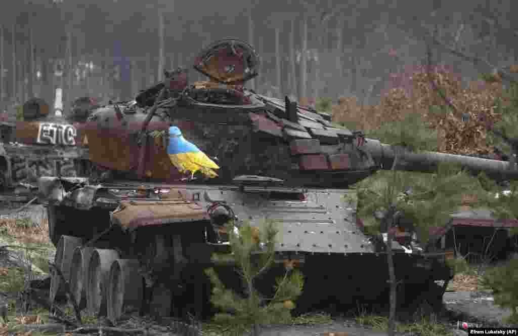 A dove with an olive branch painted in Ukraine&#39;s national colors stands in sharp contrast to a burned out Russian tank in the village of Dmytrivka, outside Kyiv, on January 30. Urban artist Tvboy, the pseudonym used by Salvatore Benintende, visited Ukraine, where his works offer messages of hope, peace, and freedom for the war-scarred country. &nbsp;