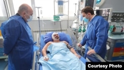 Bulgarian Foreign Minister Nikolay Milkov (left) and North Macedonia's foreign minister, Bujar Osmani, visited Hristijan Pendikov in the hospital on January 22 after he was attacked and beaten over the weekend in Ohrid, North Macedonia.