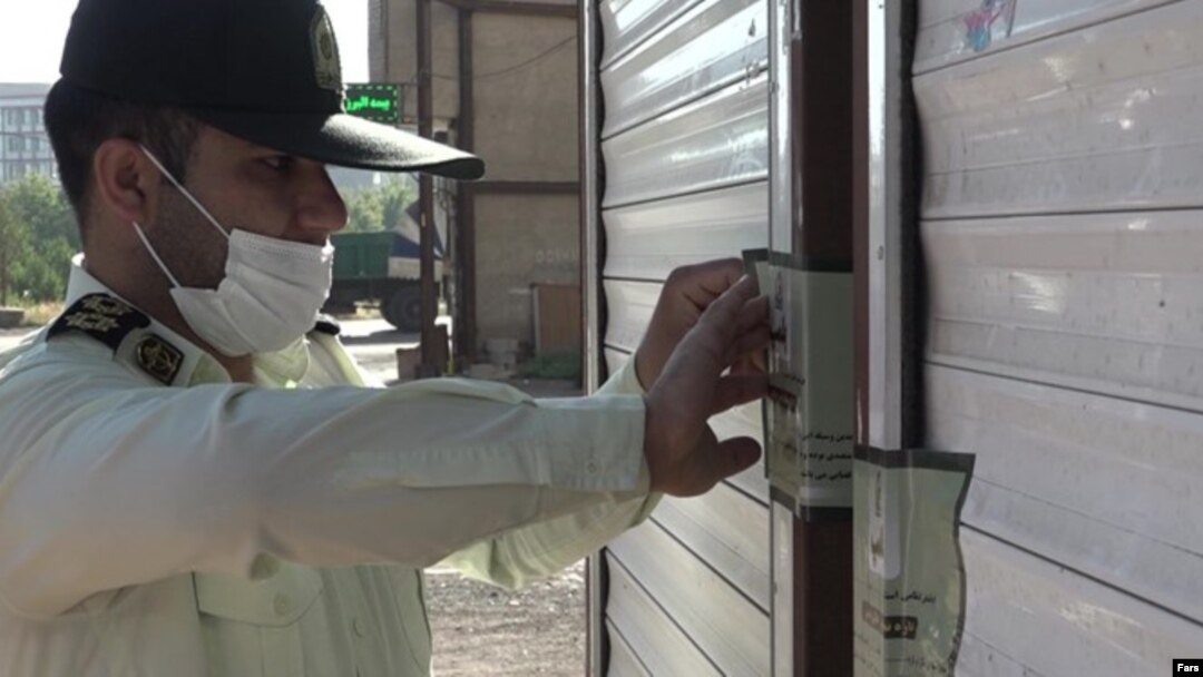 An official seals the door of a restaurant in the southern city of Mahshahr after a woman sang at its opening.