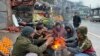 Vendors warm themselves over a fire at a market in Muzaffarabad during a nationwide power outage on January 23.<br />
<br />
Officials say most of Pakistan was struck by a power outage as an energy-saving measure by the government backfired.