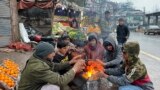 Vendors warm themselves over a fire at a market in Muzaffarabad during a nationwide power outage on January 23.<br />
<br />
Officials say most of Pakistan was struck by a power outage as an energy-saving measure by the government backfired.