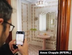 Një vizitor duke fotografuar një banjë brenda rezidencës së Çausheskut.