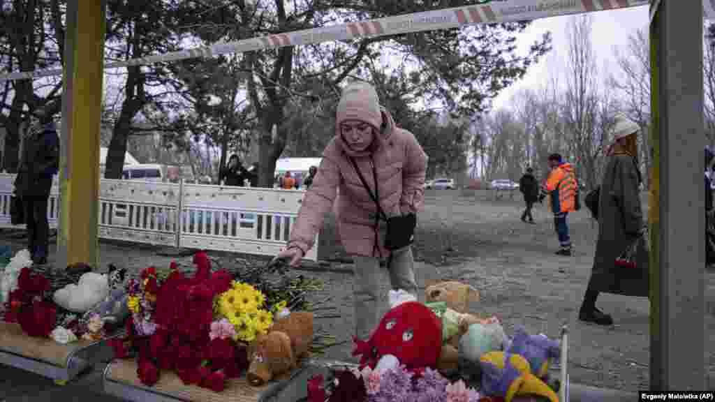 Virágokat és plüssöket helyeznek el a romok előtt az áldozatok emlékére