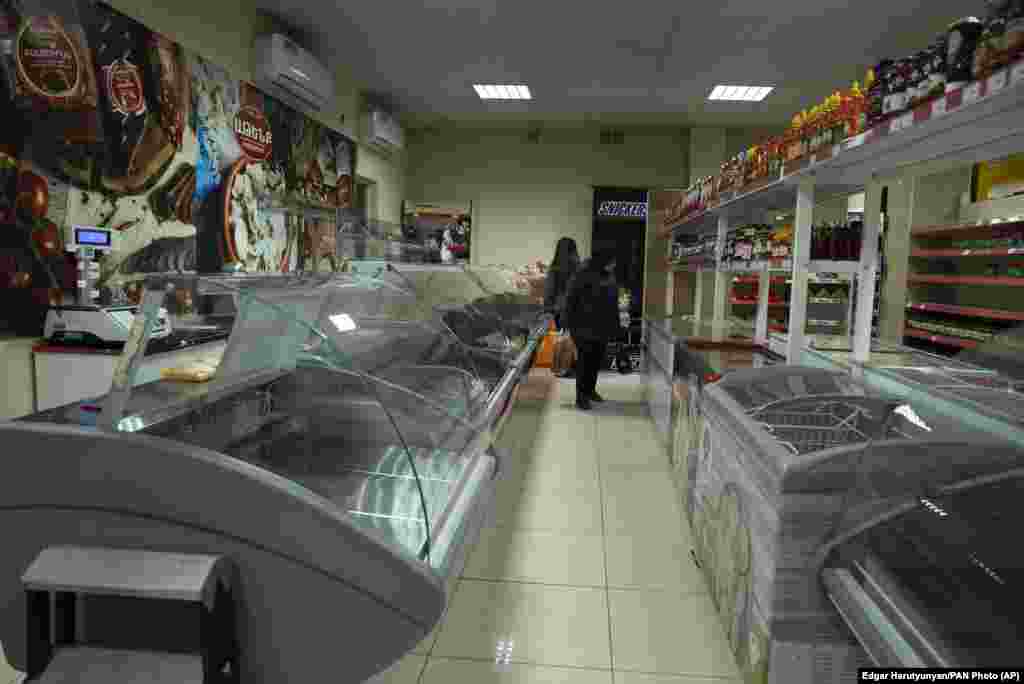 Customers visit a nearly empty food store in Stepanakert on January 7.&nbsp;After more than a month of blockages, residents of Nagorno-Karabakh have told RFE/RL that there are food, medicine, and fuel shortages.