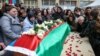 People gather around the coffin of Orkhan Askerov, a security guard at Azerbaijan's embassy in Iran who was shot dead by a gunman in an attack, in Baku on January 30.