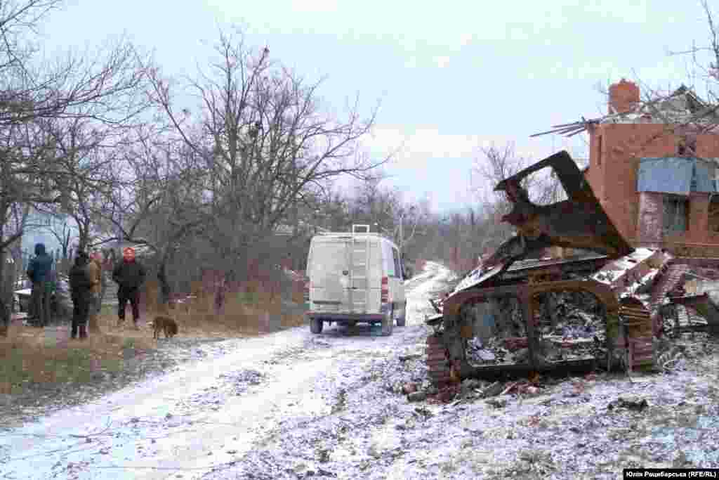 Dubovikov (wearing an orange hood) speaks with locals in&nbsp;Bohorodychne.&nbsp; The volunteer has made several delivery runs to&nbsp;Bohorodychne, where just five people now live. Around 50 animals are currently struggling to survive winter in the village.&nbsp;