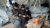 Ukrainian children attend an online class in a makeshift classroom built by them from wooden poles and plastic sheeting in a village in the Kharkiv region. (file photo)