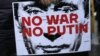 A protester holds a banner depicting Russian President Vladimir Putin during a protest organized by the Russian Democratic Society in Belgrade in December 2022.