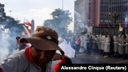 A protester reacts during the 'Take over Lima' march to demonstrate against Peru's President Dina Boluarte