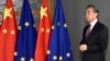 Former Chinese Foreign Minister Wang Yi stands next to the EU and Chinese flags as he waits for the arrival of European Council President Charles Michel in Brussels in 2019.