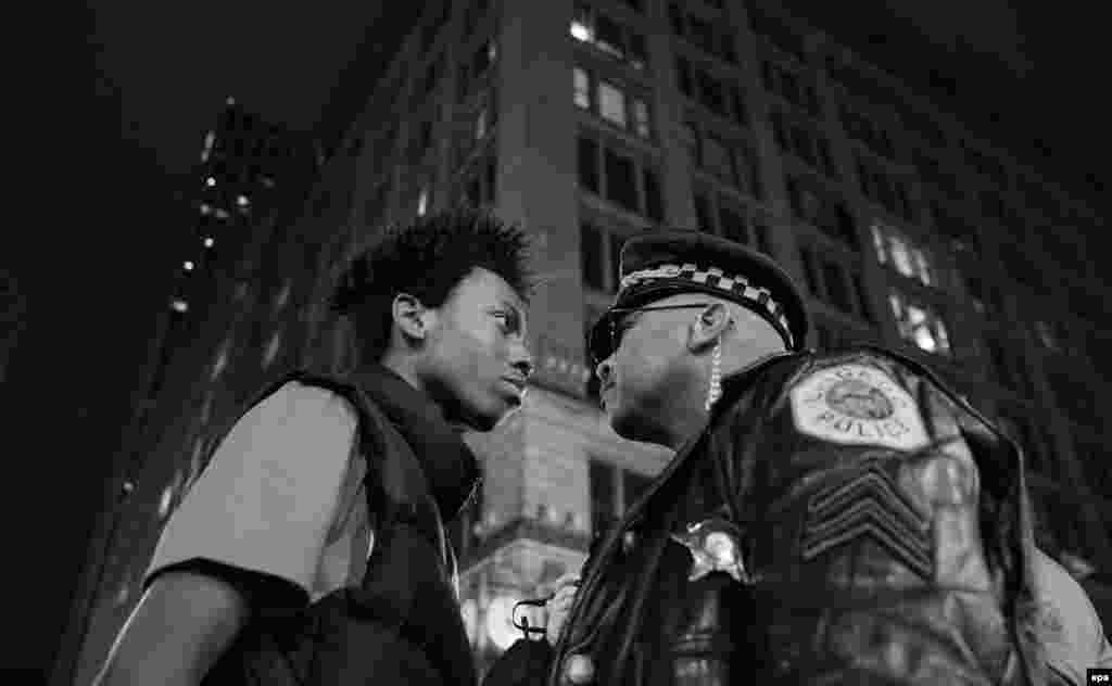 Third Prize Singles in the Contemporary Issues category was won by Chicago Tribune photographer John J. Kim. The photo shows Lamon Reccord staring down a police sergeant during a protest following the fatal shooting of Laquan McDonald by police in Chicago, Illinois. (November 25, 2015)