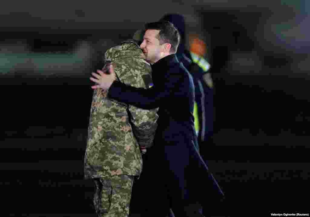Zelenskiy (right) welcomes a Ukrainian serviceman who was exchanged during a prisoner swap with Russia-backed separatists at Boryspil International Airport outside Kyiv on December 29.