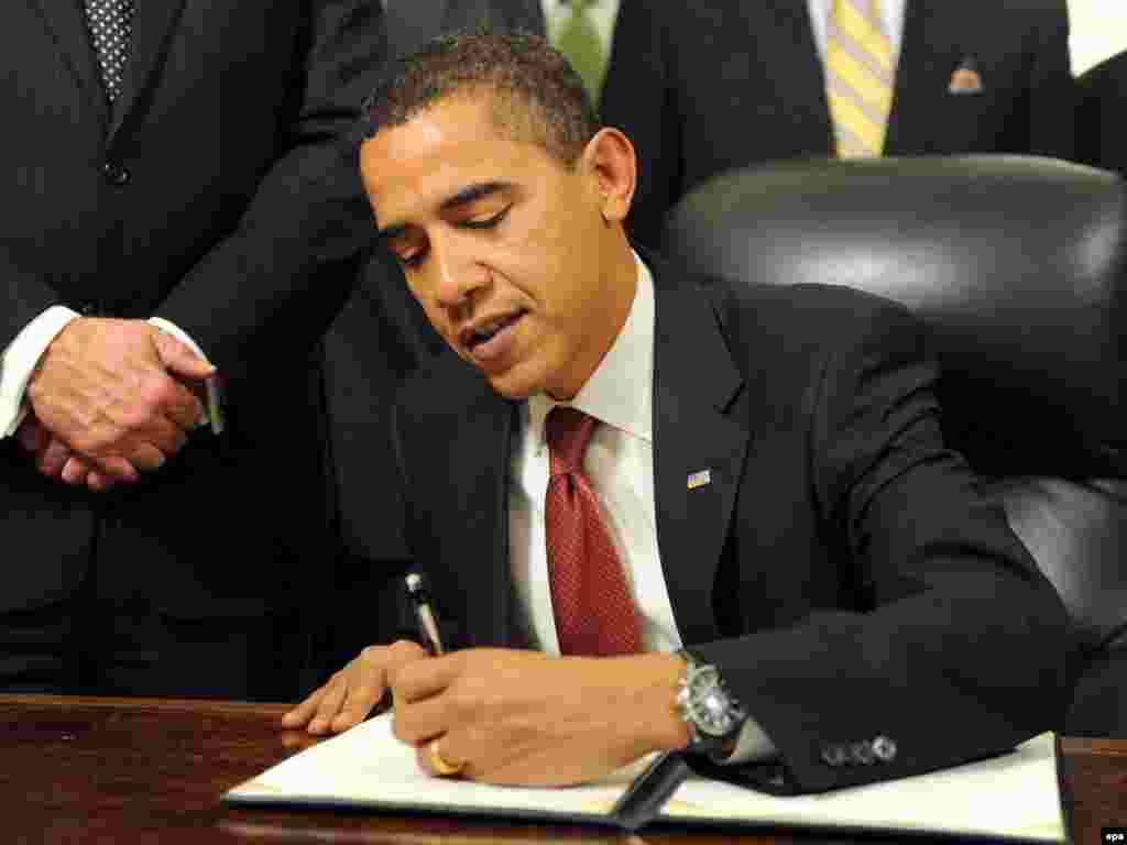 U.S. President Barack Obama signs the second of three executive orders to close the Guantanamo Bay detention facility at the White House on January 22, 2009. Obama has backed down on his pledge to close the facility, but no new prisoners have been brought
