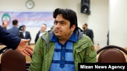 Rouhollah Zam who was captured by Iranian intelligence last year, facing a hardliner judge during his trial in Tehran. February 10, 2020