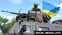Украинский военнослужащий стоит на верху бронеавтомобиля возле Краматорска Донецкой области