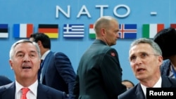 Montenegro's Prime Minister Milo Djukanovic (left) and NATO Secretary-General Jens Stoltenberg attend a NATO foreign ministers meeting at alliance headquarters in Brussels on May 19.
