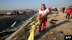 Rescue teams recover debris from the crash site on January 8. 