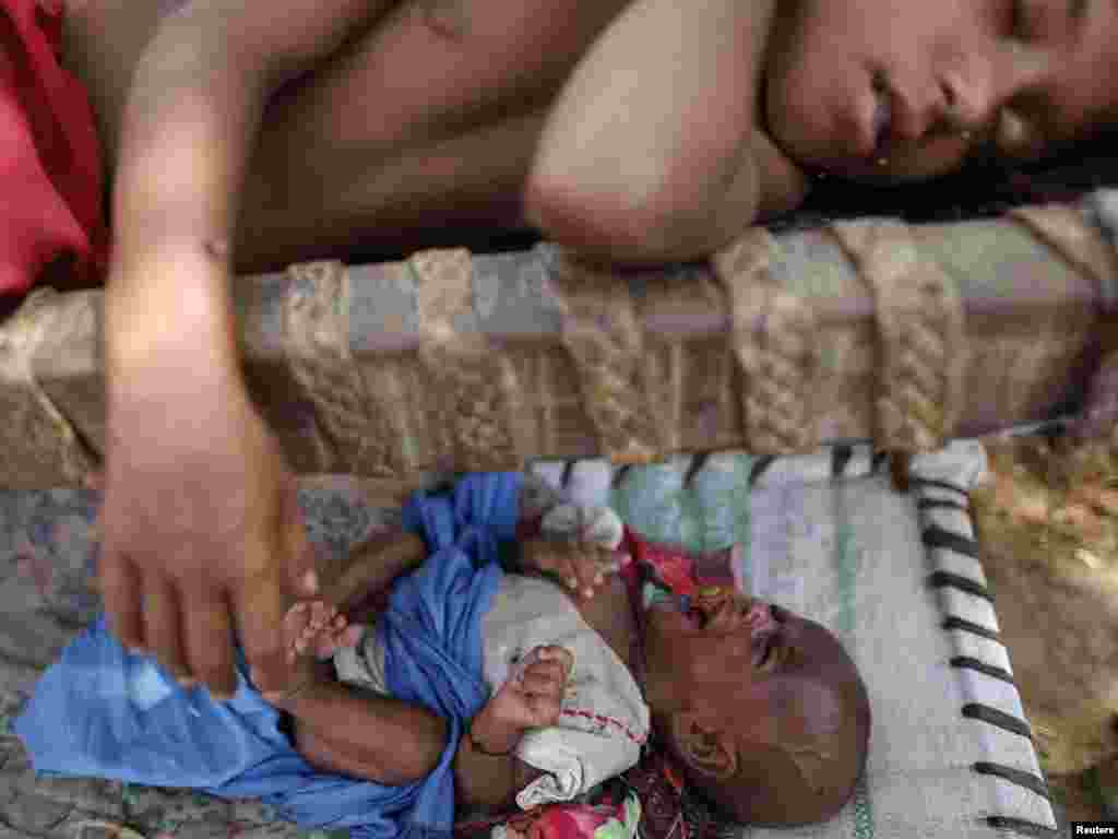 A baby cries as flood victims take shelter near their flooded village in Muzaffargarh District of Pakistan's Punjab Province on September 6. Some 20 million Pakistani people are affected by floods that have destroyed cropland and livestock, causing damage the government has estimated at $43 billion, or almost one-quarter of the South Asian nation's 2009 GDP. Photo by Damir Sagolj for Reuters