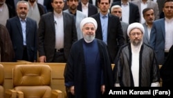 Iranian President Hassan Rouhani (left foreground) with Ayatollah Sadeq Larijani, the chief of Iran's Judiciary and now the new head of the Expediency Council