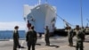 Members of the army are seen, as the USNS Mercy, a Navy hospital ship, departs the Naval Station San Diego and heads to the Port of Los Angeles to aid local medical facilities dealing with coronavirus disease (COVID-19) patients, in San Diego, California,