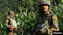 Indian Army soldiers patrol near the Line of Control, a ceasefire line dividing Kashmir between India and Pakistan, on August 7. 