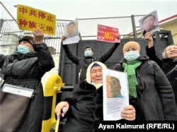 People protest on February 9 outside the Chinese Consulate in Almaty to demand the release of their loved ones who they believe are being held against their will in China's northwestern region of Xinjiang.